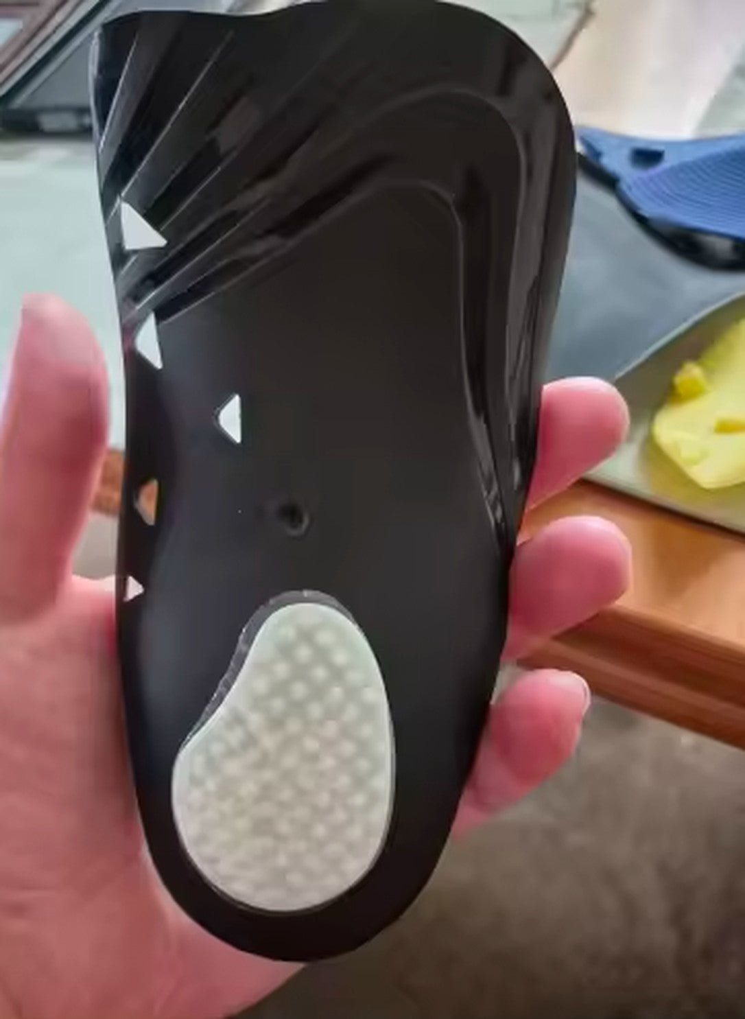 Customer photo of the underside of a Heelora insole with its heel pad